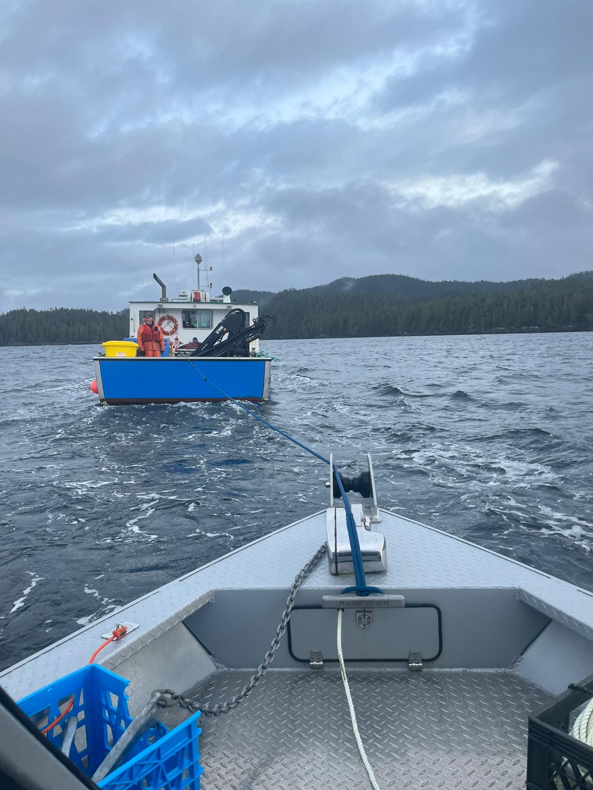 Salmon farm boat towing us